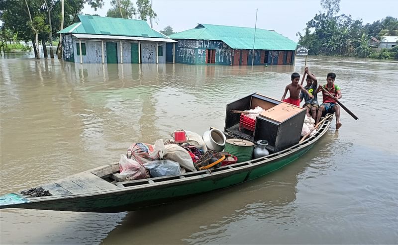 বন্যার পানি বাড়তে থাকায় নৌকায় আসবাব নিয়ে নিরাপদ আশ্রয়ে যাচ্ছে একটি পরিবার। আজ রোববার সকালে জামালপুরের ইসলামপুর উপজেলার বলিয়াদহ এলাকায়