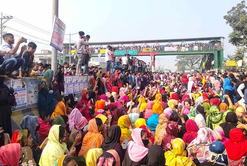 বেতন বাড়ানোর দাবিতে মহাসড়কে জুতা তৈরির কারখানার শ্রমিকদের বিক্ষোভ। আজ শনিবার সকালে ঢাকার ধামরাইয়ে ঢাকা-আরিচা মহাসড়কে