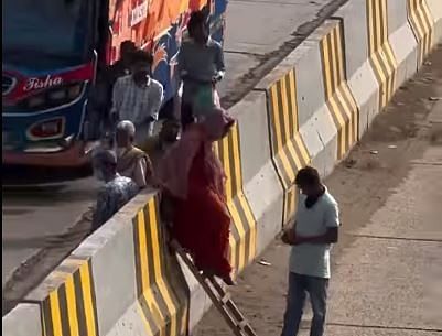 টাকার বিনিময়ে মই দিয়ে পথচারীদের সড়ক বিভাজক পার করা হচ্ছে। ঢাকা-চট্টগ্রাম মহাসড়কের নারায়ণগঞ্জের সিদ্ধিরগঞ্জের শিমরাইলে