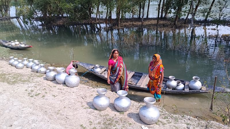 কয়রার মহেশ্বরীপুর এলাকার তহশিল অফিস–সংলগ্ন পুকুর থেকে মিঠাপানি সংগ্রহ করছেন দুই নারী। বৃহস্পতিবার তোলা