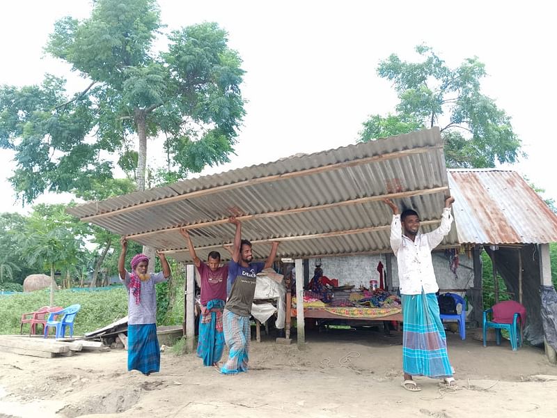 ব্রহ্মপুত্র নদের ভাঙন শুরু হওয়ায় ভিটে থেকে ঘর সরিয়ে নেওয়া নিচ্ছেন ময়মনসিংহের গৌরীপুরের খোদাবক্সপুর এলাকার বাসিন্দা আবদুল খালেক। আজ দুপুরে তোলা