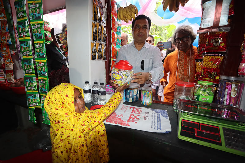 মাসুরার দোকান থেকে চকলেট কিনছেন রাজশাহী জেলা প্রশাসক শামীম আহমেদ। আজ মঙ্গলবার সকালে রাজশাহীর পবা উপজেলার পারিলায়