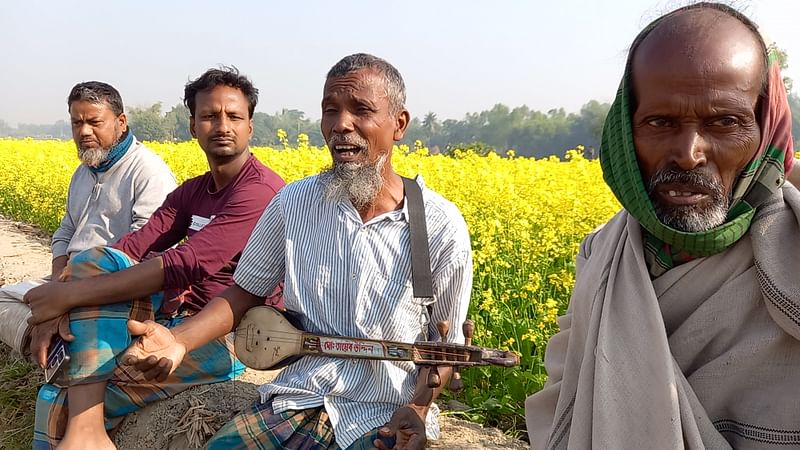 ফসলি মাঠে কৃষিশ্রমিকদের গান শোনাচ্ছেন গায়েন তায়েব উদ্দিন। সম্প্রতি দিনাজপুরের বিরামপুর উপজেলার বেনুপুর গ্রামে