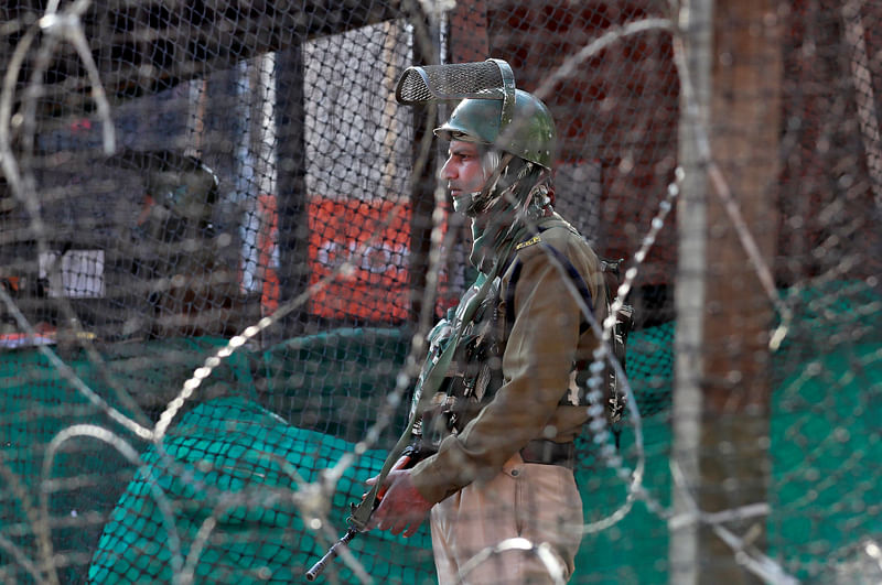 An Indian policeman stands guard outside a bunker alongside a road in Srinagar 31 October 2019.