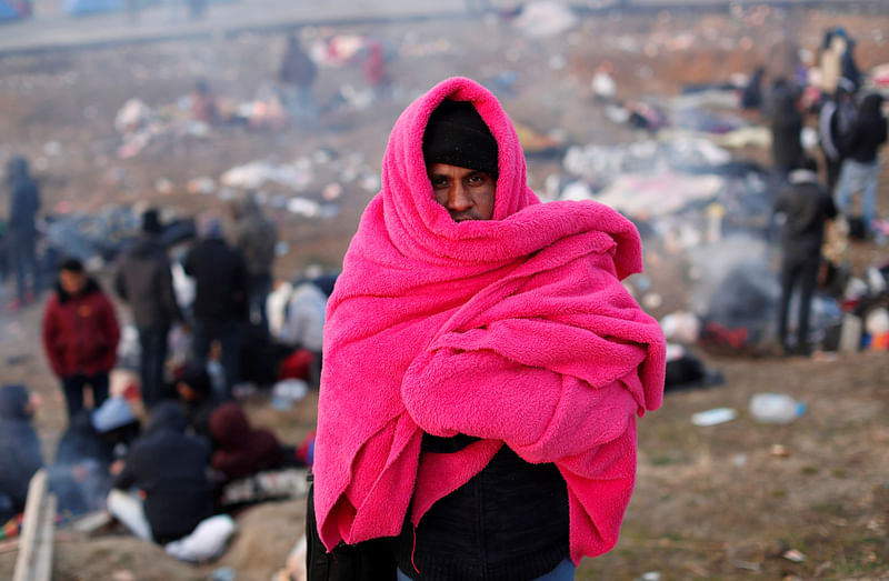 A migrant from Bangladesh waits on a road side near Turkey's Ipsala border crossing with Greece's Kipi, in Edirne, Turkey, 2 March 2020.