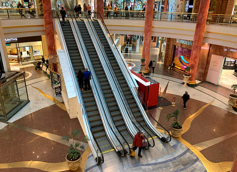 Shoppers are seen inside a deserted Intu Trafford Centre amid coronavirus outbreak in Manchester, Britain, on 18 March 2020