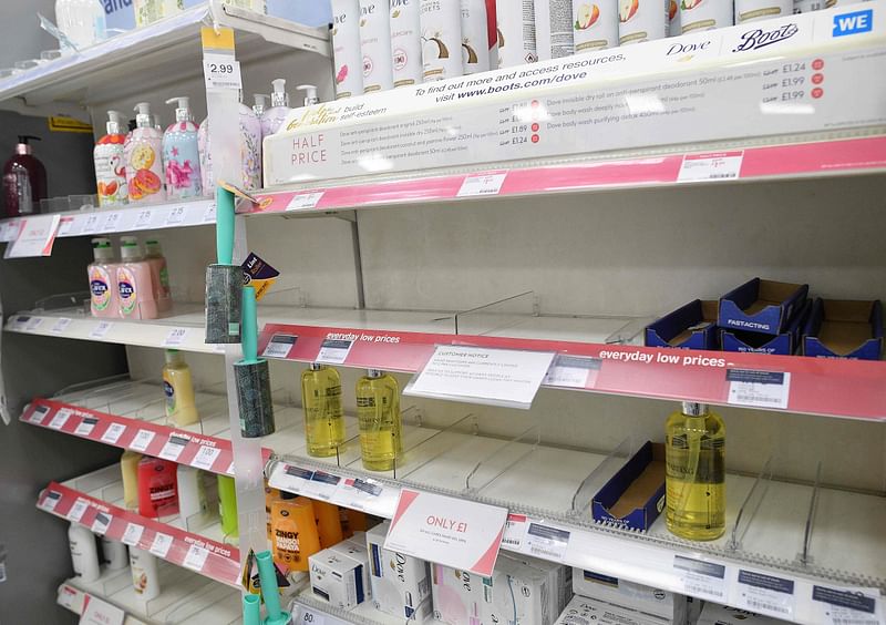 A sign alerts customers of limited sales of antibacterial hand washes and sanitiser gels, at a London store on 3 March 2020. AFP