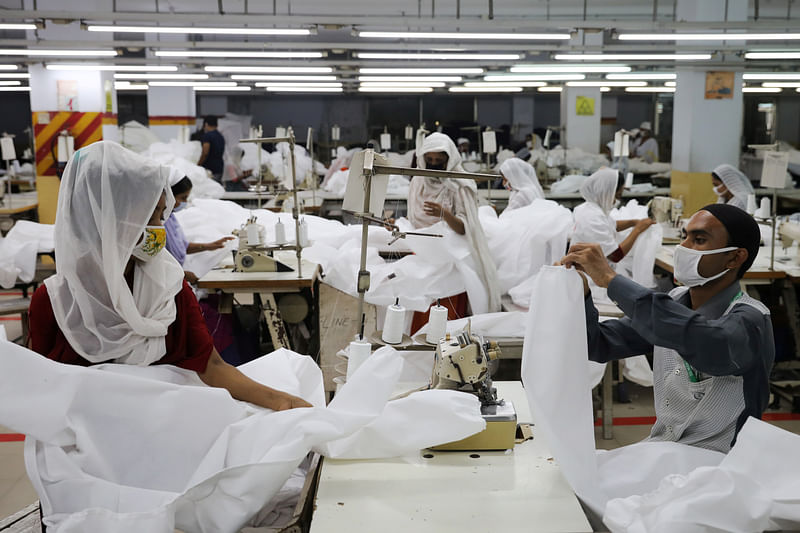 Bangladeshi garment workers make protective suit at a factory amid concerns over the spread of the coronavirus disease (COVID-19) in Dhaka, Bangladesh, on 31 March 2020