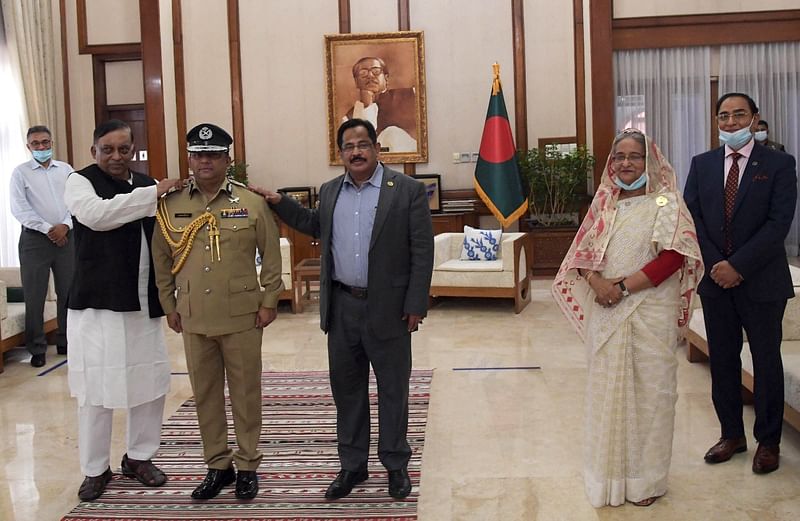 Home minister Asaduzzaman Khan and senior secretary Mustafa Kamal Uddin adorn the Rank Badge to new IGP in presence of prime minister Sheikh Hasina at her official Ganabhaban residence, Dhaka on 15 April