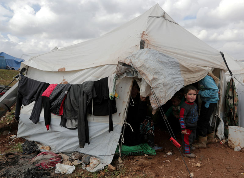 An internally displaced Syrian child from Idlib, stands outside a tent in Azaz, Syria on 22 February.