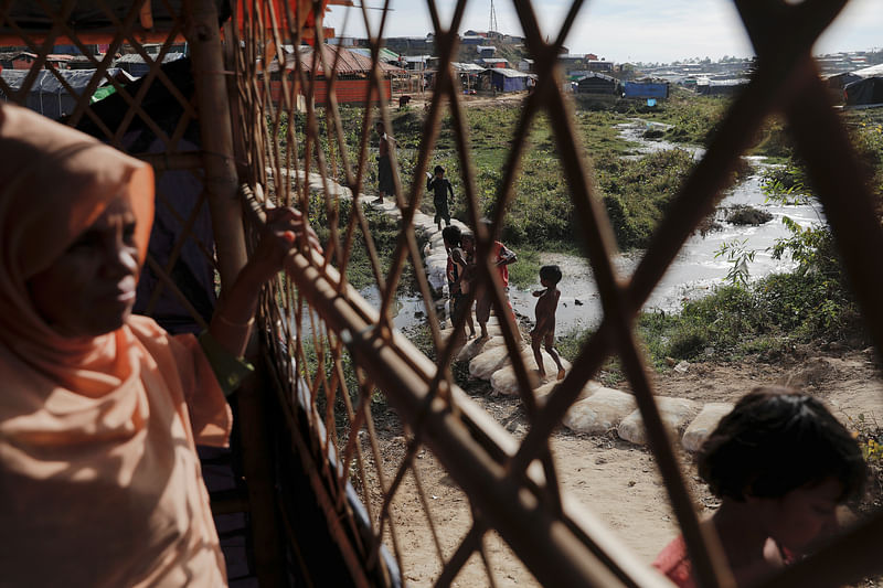 A Rohingya refugee looks from inside a kitchen of the camp for widows and orphans inside the Balukhali camp near Cox's Bazar, Bangladesh, on 5 December 2017