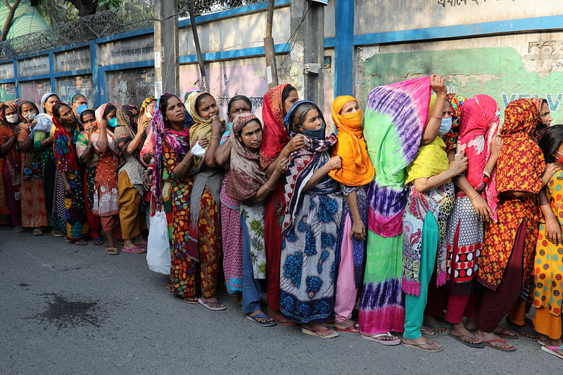 Women stand in a queue to receive relief supplies provided by local community amid the coronavirus disease (COVID-19) outbreak in Dhaka, Bangladesh on 1 April.