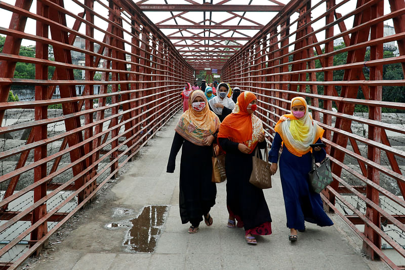 Garment workers return after their work as garment factories reopened amid concerns over the coronavirus disease (COVID-19) outbreak in Dhaka, Bangladesh, 27 April 2020.