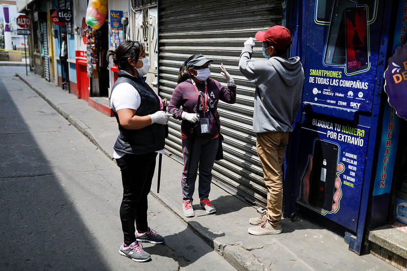 Community members wearing protective masks talk to a person breaking social restrictions amid the outbreak of the coronavirus disease (COVID-19), in Totonicapan, Guatemala on 19 April 2020