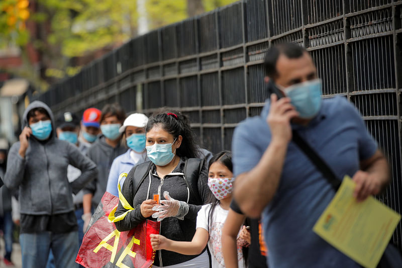 People wait in line at a food bank at St. Bartholomew Church, during the outbreak of the coronavirus disease (COVID-19) in the Elmhurst section of Queens, New York City, New York US, 15 May 2020.