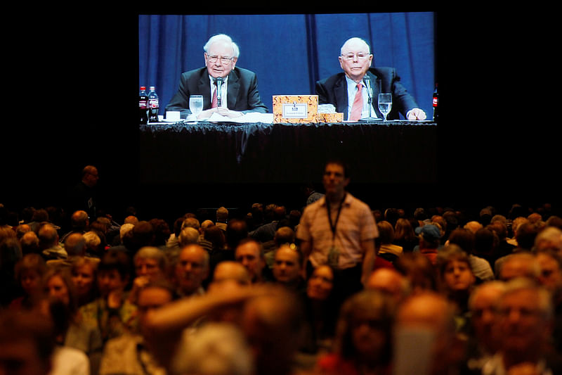 Berkshire Hathaway shareholders listen to CEO Warren Buffett and vice-chairman Charlie Munger seen on a projection screen in the background at the annual meeting in Omaha.