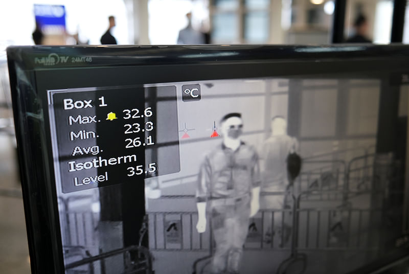 A screen shows a thermographic image of people walking through a temperature screening point at the Hong Kong International Airport, following the coronavirus disease (COVID-19) outbreak, in Hong Kong, China 7 May 2020.