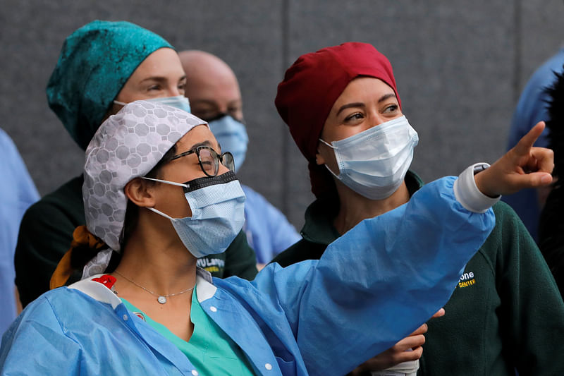 Healthcare workers react as people clap for them on National Nurse Day outside NYU Langone Health during the outbreak of the coronavirus disease (COVID-19) in the Manhattan borough of New York City, US, 6 May 2020.