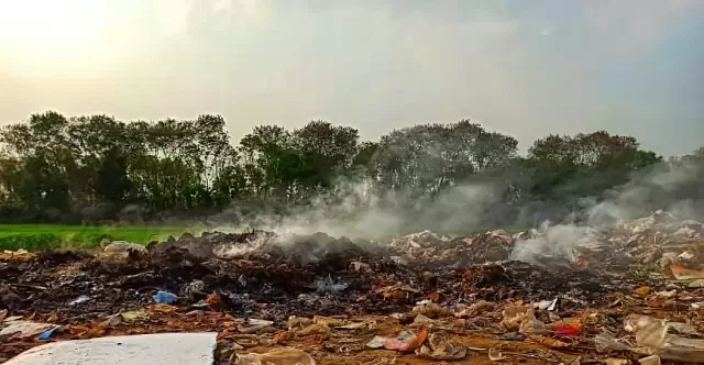 Smokes belch out from garbage alighted along river Kopotakkho