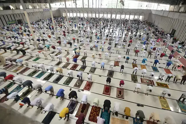 People attend Eid prayer at Baitul Mukarram National Mosque while maintaining social distance.