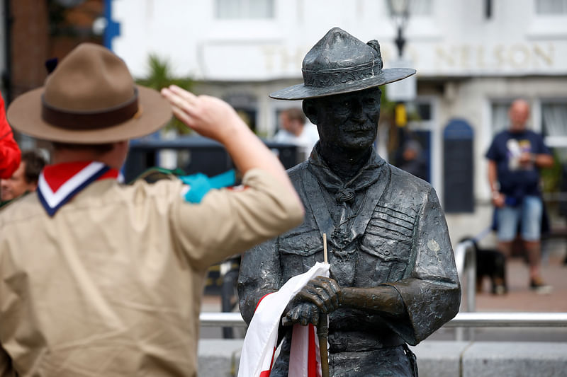 Matthew Trott a Scout from the Thane Rover Crew of Cwmbran in Wales salutes a statue of Robert Baden-Powell in Poole, the statue is due to be removed following protests against the death of George Floyd who died in police custody in Minneapolis, Poole, Britain, on 11 June 2020