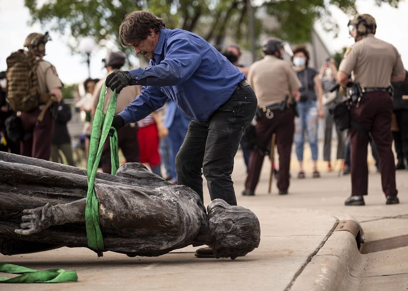 A statue of Christopher Columbus, which was toppled to the ground by protesters, is loaded onto a truck on the grounds of the State Capitol on 10 June 2020 in St Paul, Minnesota