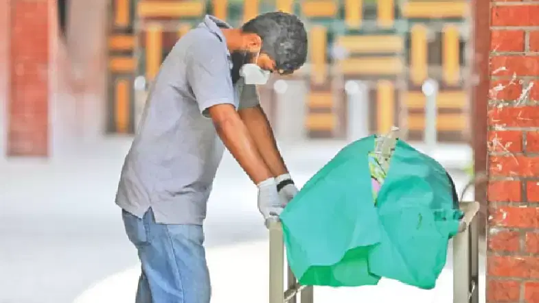 A man reacts before the body of his father, a ward master at Suhrawardy Hospital in Dhaka, who died under treatment at the hospital after showing coronavirus symptoms. The deceased was Covid-19 positive in the test report received after death.