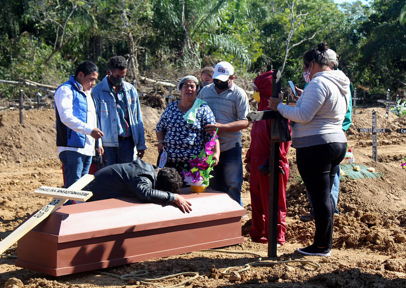 People mourn a victim of the coronavirus disease (COVID-19), at a cemetery known locally as "the COVID-19 cemetery", in Trinidad, Bolivia 7 June.