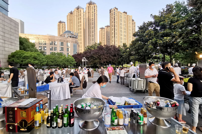 Diners are seen at tables placed outside Sheraton Wuhan Hankou Hotel in Wuhan, the Chinese city hit hardest by the coronavirus disease (COVID-19) outbreak, in Hubei province, China 19 May.