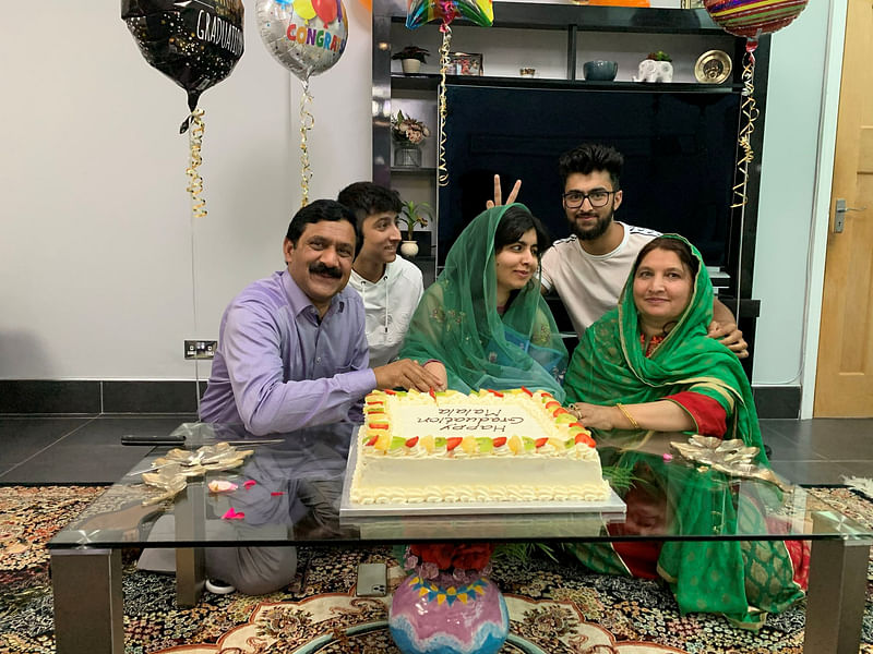 Activist Malala Yousafzai celebrates with family after completing her philosophy, politics and economics degree from Oxford University, 18 June 2020 in this picture taken in an undisclosed location and obtained from social media.