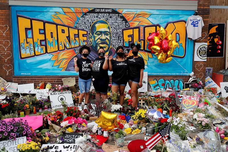 Protesters react as they leave items to memorialize George Floyd, who died in Minneapolis police custody, at the scene of his arrest in Minneapolis, Minnesota, US, on 4 June 2020