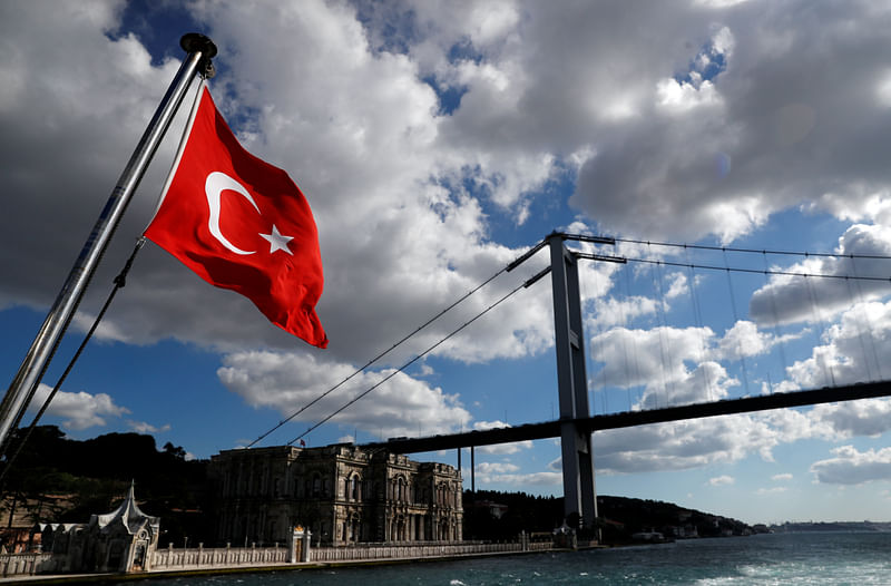 A Turkish flag with the Beylerbeyi Palace and the Bosphorus Bridge in the background flies on a passenger ferry in Istanbul, Turkey, 9 July  2020.