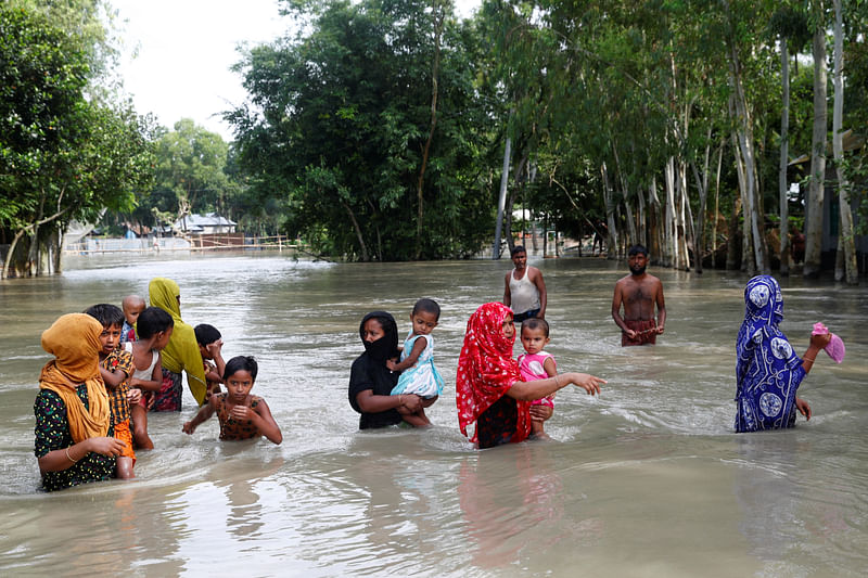 Flood-affected people are seen on water as they wait for a boat to cross a stream in Jamalpur, Bangladesh, 18 July, 2020