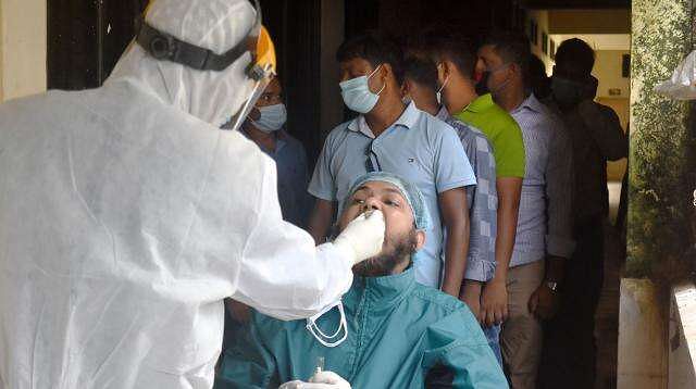 Sample of patient being taken for COVID-19 test at General Hospital, Pabna, 6 July 2020