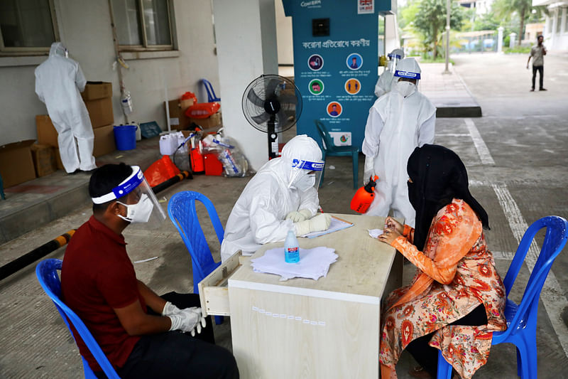 A woman consults a doctor before swab testing at Mugda Medical College and Hospital, as the coronavirus disease (COVID-19) outbreak continues, in Dhaka, Bangladesh, on 23 June 2020