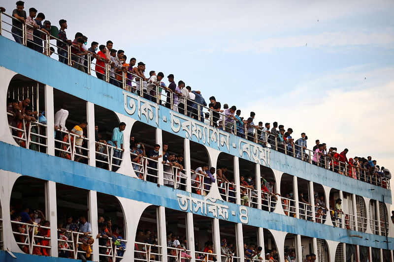 People are seen on board of an overcrowded launch at the Sadarghat launch terminal while leaving Dhaka to go home to celebrate Eid-ul-Azha, amid coronavirus outbreak, in Dhaka, 30 July 2020.