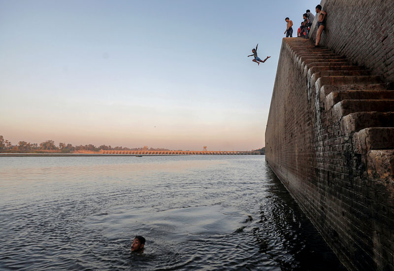 A boy jumps in the Nile River during hot weather on the outskirts of Cairo, following the outbreak of the coronavirus disease (COVID-19), Egypt, 18 August 2020.