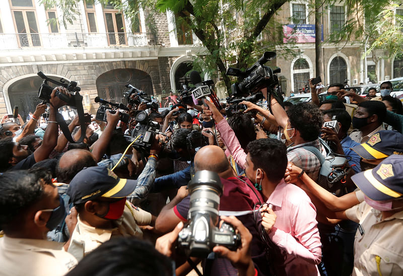 Media personnel surround Bollywood actor Rhea Chakraborty as she arrives at Narcotics Control Bureau (NCB) office for questioning, in Mumbai