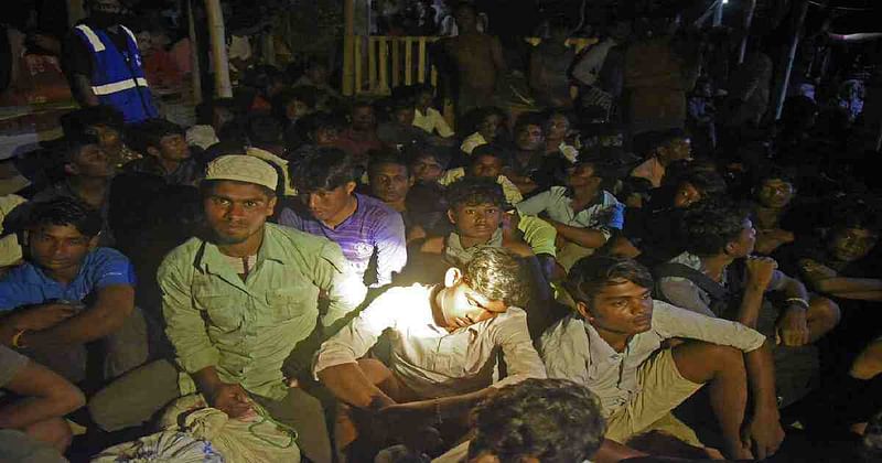 Ethnic Rohingya people rest after the boat carrying them landed in Lhokseumawe, Aceh province, Indonesia.