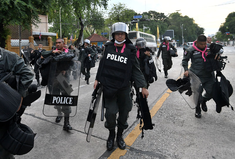 Police officers walk with their riot gear after a mass anti-government protest, on the 47th anniversary of the 1973 student uprising, in Bangkok, Thailand 15 October 2020.