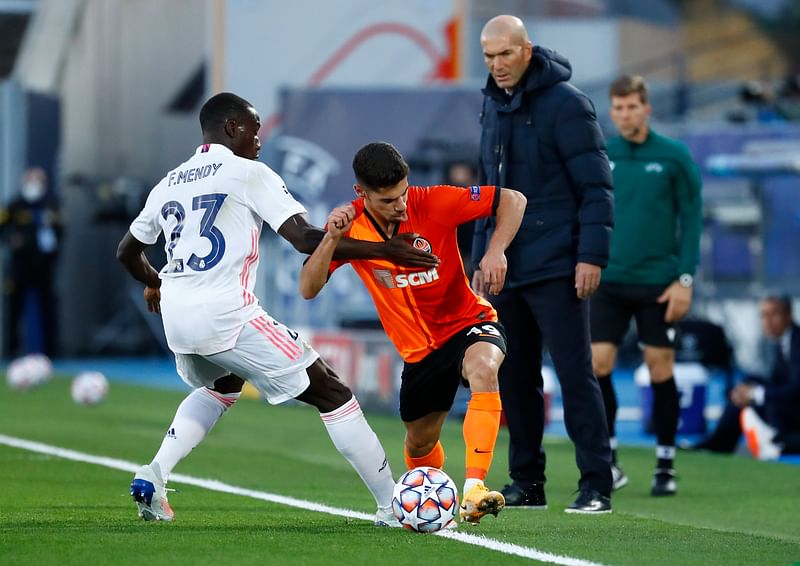 Real Madrid’s Ferland Mendy in action with Shakhtar Donetsk’s Manor Solomon as Real Madrid coach Zinedine Zidane looks on during a Champions League against Shakhtar Donetsk at Estadio Alfredo Di Stefano, Madrid, Spain on 21 October 2020