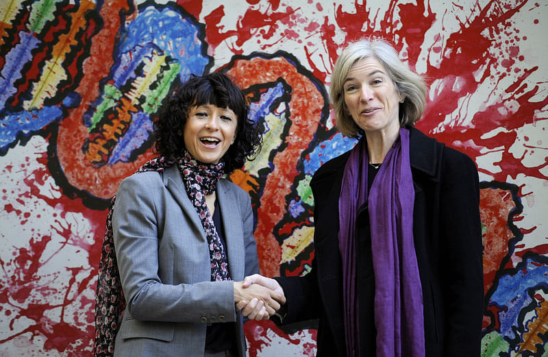 French microbiologist Emmanuelle Charpentier (L) and professor Jennifer Doudna of the US pose for the media during a visit to a painting exhibition by children about the genome, at the San Francisco park in Oviedo, Spain, on 21 October 2015