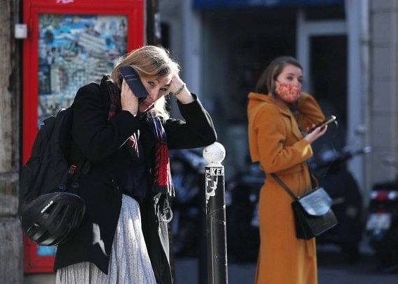 A woman talks on the phone in Paris, France, on 9 November 2020