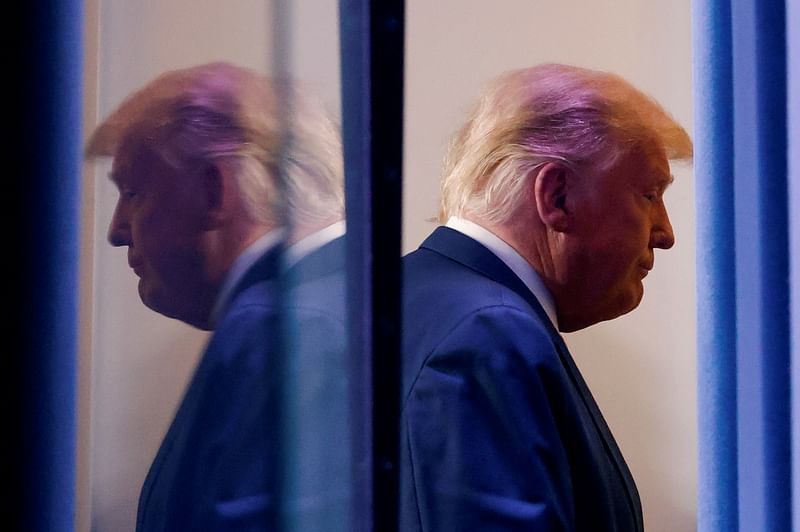 US president Donald Trump is reflected as he departs after speaking about the 2020 US presidential election results in the Brady Press Briefing Room at the White House in Washington, US, 5 November, 2020