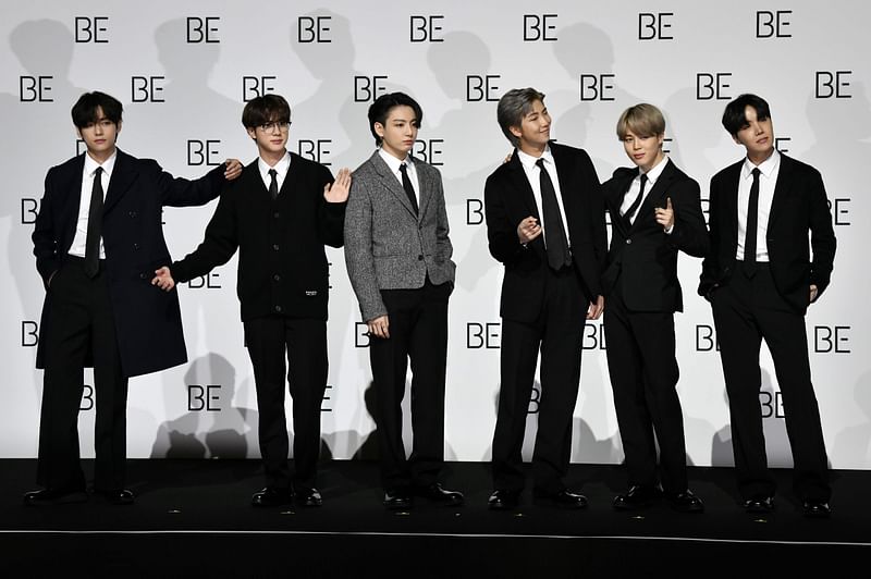 South Korean K-pop boy band BTS members (L to R) V, Jin, Jung Kook, RM, Jimin and J-Hope pose for a photo session during a press conference on BTS new album 'BE (Deluxe Edition)' in Seoul on 20 November 2020