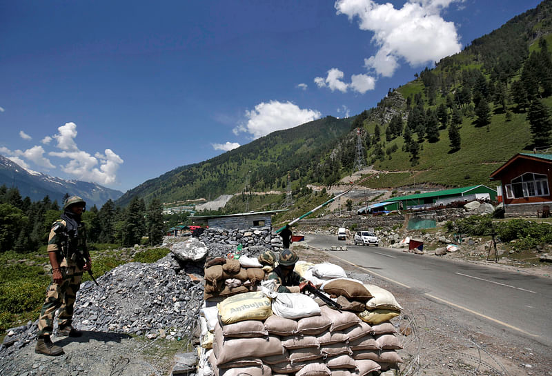 India's Border Security Force (BSF) soldiers stand guard at a checkpoint along a highway leading to Ladakh, at Gagangeer in Kashmir's Ganderbal district 17 June, 2020.