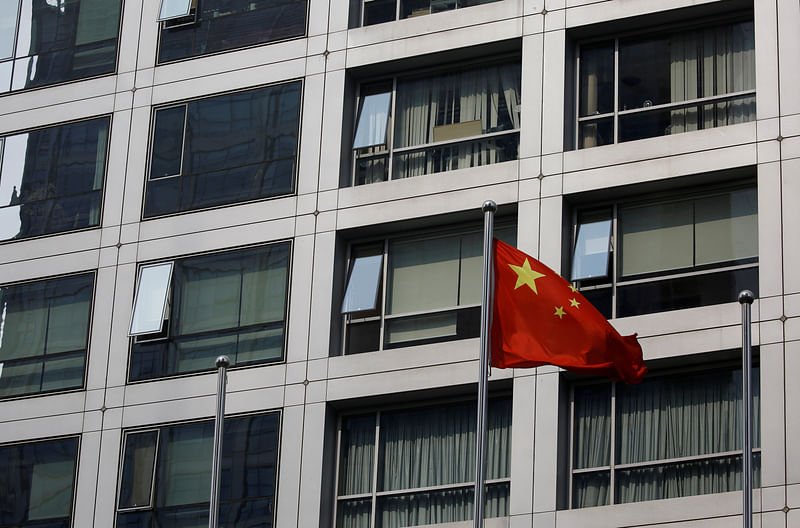 A Chinese national flag flutters near the building of China Securities Regulatory Commission (CSRC) at the Financial Street area in Beijing, China on 16 July 2020