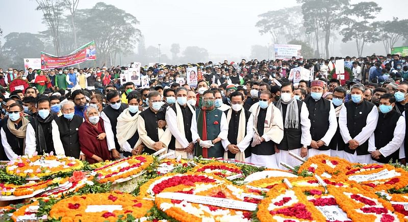 Awami League general secretary and road transport and bridges minister Obaidul Quader along with other party leaders pose for a photo after paying homage to the martyrs of the Liberation War by placing wreaths at the National Memorial in Savar, on behalf of the party, marking the Victory Day on 16 December 2020