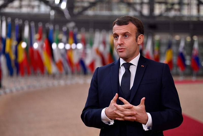 France's president Emmanuel Macron speaks to the press as he arrives at the EU headquarters' Europa building in Brussels on 10 December 2020, prior to a European Union summit