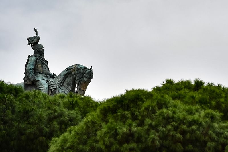 In this file photo taken on 22 October 2018 the equestrian statue of Italian King Victor Emmanuel II, or Vittorio Emanuele II, is pictured behind pine trees on Piazza Venezia in Rome